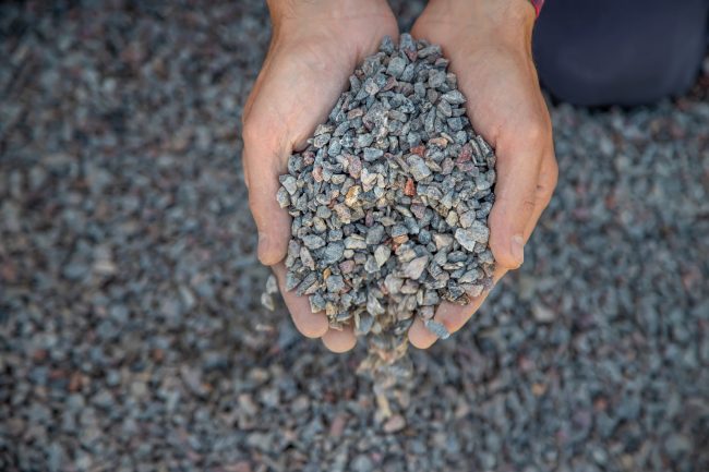 Crushed stone quarry in the hands of a man. Selective focus.